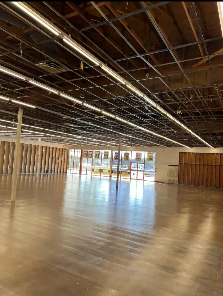 Wide open hall with polished concrete floor under an exposed timber roof structure