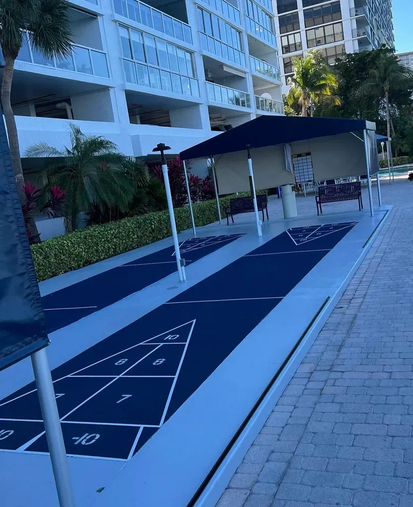 Blue shuffleboard court painted and sealed in a residential condominium courtyard