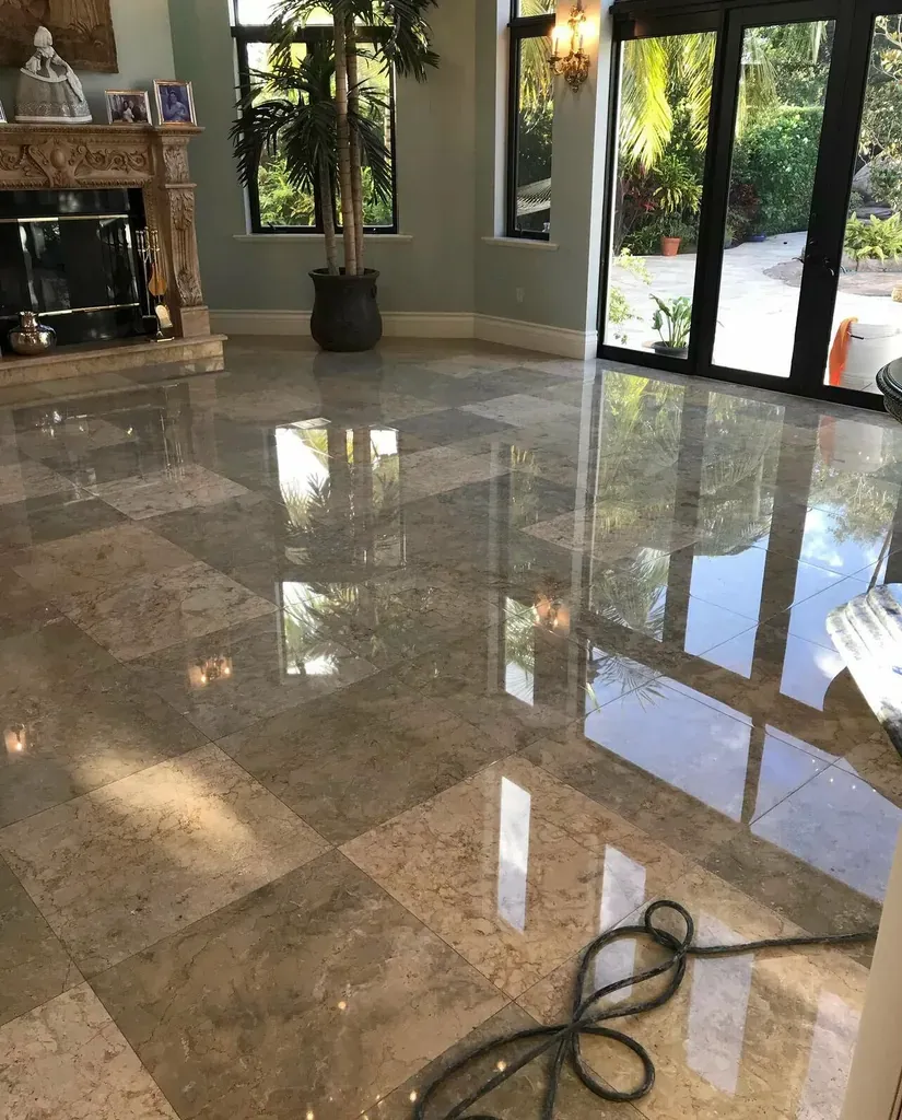 Polished marble floor in a checkerboard pattern in a residential living room with tall windows